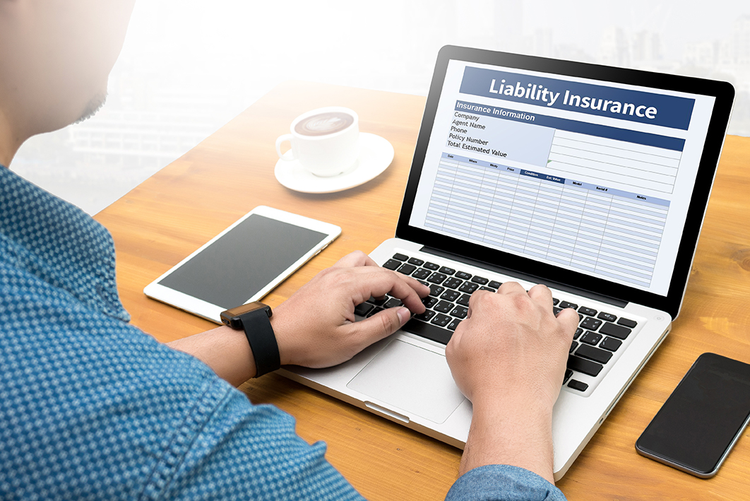 Liability Insurance - Typing On Laptop